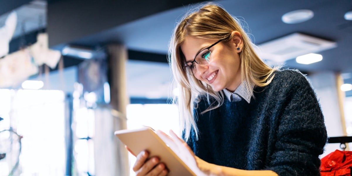 professional woman in office holding tablet