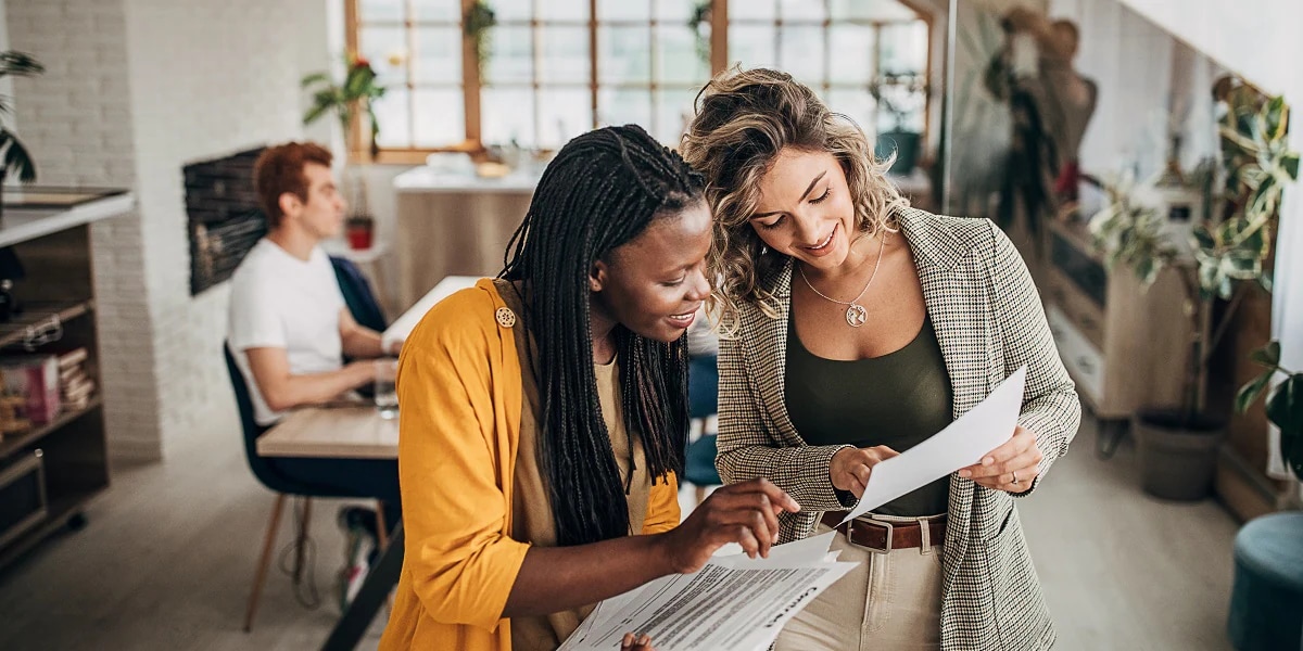 two professionals reviewing document in office